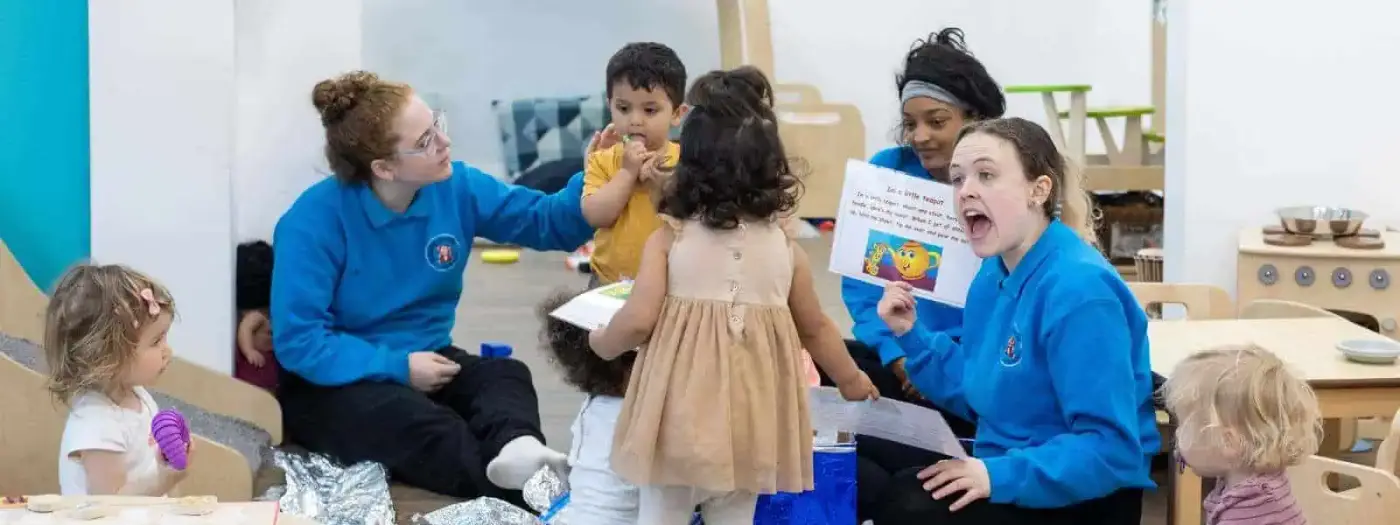 Brightly lit classroom at Monkey Puzzle Day Nurseries with caring staff engaging young children in educational activities.